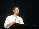 Glen Koorey standing behind a lectern