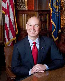 Bald man in open-collared shirt