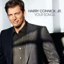 Harry Connick, Jr. in a black jacket and black shirt, white background, black text