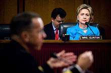 Clinton listening at a Senate hearing