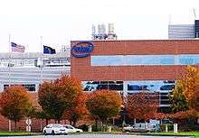 Red brick and metal office and production facility at Intel Corporation's Ronler Acres campus. Building is the main entrance and includes the company's logo on the exterior.