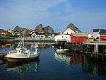 A small fishing boat docked in a small fishing village