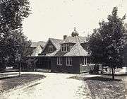 A shingled two-story building and driveway