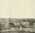 photo of fort yard with dirt-covered timbers leaned against interior walls and ditches cutting across