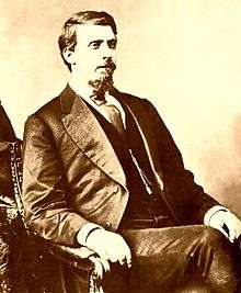 Photo of middle-aged man in a suit facing slightly to the right of camera.