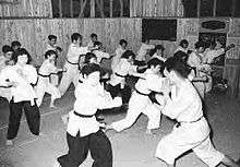 Japanese men and women practicing kenpo, circa 1955.