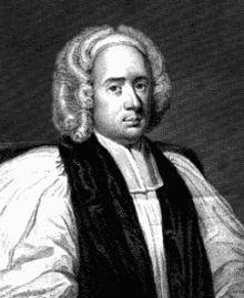 A middle-aged white man seated and wearing Georgian-era English clerical robes.