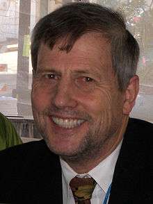 Head shot of Mr Marlantes wearing jacket and necktie.   There is some greying of the temples, and he seems unshaven.