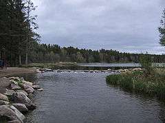 A small river flows from a lake.