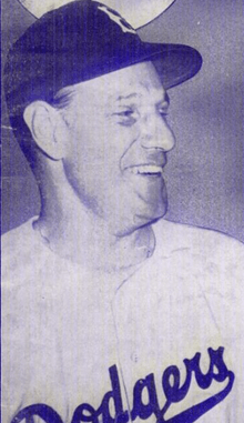 A man wearing a baseball cap with a "B" emblazoned on it and a jersey that reads "Dodgers"