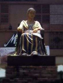 A statue of a sitting woman