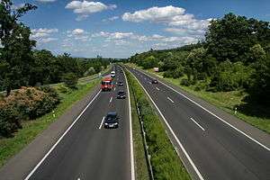 A view of four lane motorway with a central reservation, taken from an elevated point