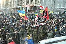 Large group of demonstrators, waving flags