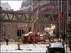 Fire engine with extended ladder in a street full of rubble