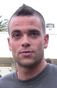 A young man has a mohawk hairstyle.