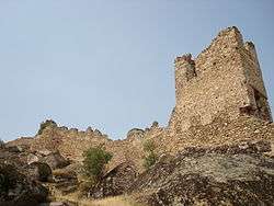 Stone castle ruins against a blue sky