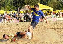 Macri taking part in a friendly match of beach soccer.