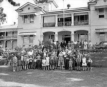 Migrant group on the lawn at Yungaba, 24 June 1958