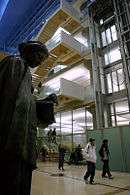 Patrons walking towards door in modern lobby with 19th C.  bronze sculpture of Minerva by Jakob Fjelde on left