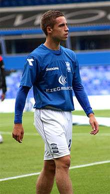 Young man wearing blue and white sports clothing