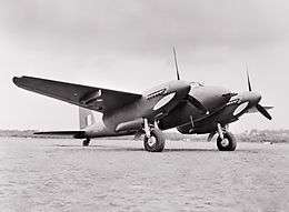 Twin-engined military monoplane parked on airfield