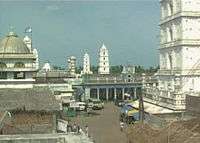 twin minarets with two minarets in the background