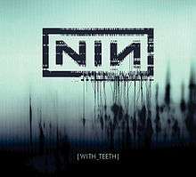 The letters NIN set against a blue background with black, organic-looking outcroppings of black.