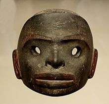 A dark stone mask, free standing