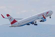 Rear quarter view of an Austrian Airlines 767 takeoff, with red winglets.