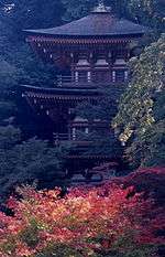 Wooden pagoda with white walls and vermillion red beams.