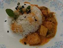 Paneer Curry with chaunk (containing vegetable oil, cumin seeds, green chilies) on rice.