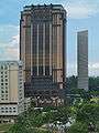 Distant view of a 25-storey building with a bronze facade and several vertical ridges that continue upward to the roofline