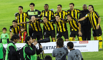 Players in uniform, posing for photographers