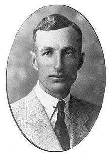 An ovular photographic portrait of a man in a jacket and tie