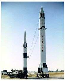 Pershing missile next to Redstone missile illustrating difference in height and range