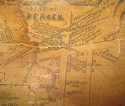 An old map on yellowed paper headlined "Plan of Bergen" showing the businesses there, the roads and the railroad line