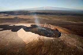 Looking up the slope of Kīlauea, a shield volcano on the island of  which is the largest and the southeastern-most of the Hawaiian islands. In the foreground, the  vent has erupted fluid lava to the left. The  crater is at the peak of Kilauea, visible here as a rising vapor column in the background. The peak behind the vapor column is Mauna Loa, a volcano that is separate from Kīlauea.