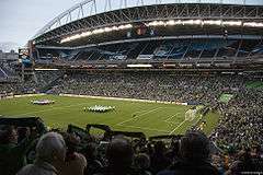 A view of a soccer field from high in the crowd before a match.