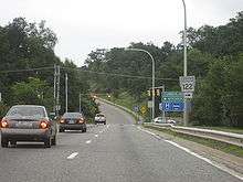 Ground-level view of an at-grade intersection with a traffic signal