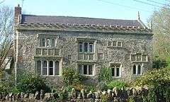 Gray stone building with a slate roof.