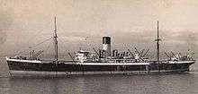 Sepia-toned image of a ship in open waters with a smokestack at center and two masts on either side of the funnel.