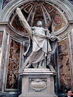  This statue shows an elderly man, bare-chested, and draped, looking up despairingly as he supports a large cross, arranged diagonally.