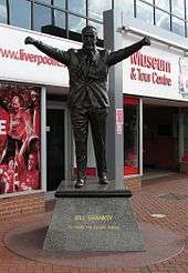 Statue of a man with his arms held aloft