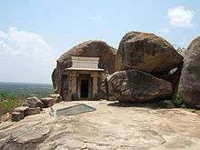 Entrance to cave dug into a rock