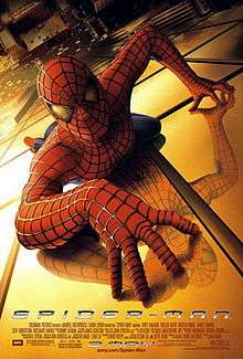 Spider-Man,in his famous suit, crawling over a building, looking towards the viewer, below of him there is New York City and the film's title, credits and release date.