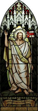 High resolution, perspective corrected stained-glass image of Jesus with a halo, dressed in white and gold robes, with his hand raised, and the banner "I am the Resurrection and the Life", together with a dedication to a deceased parishioner