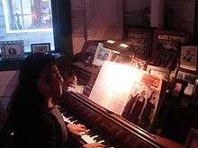 An interior photo of the historic Talkeetna Roadhouse's fireside parlor piano.