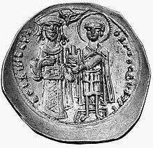 Round silver coin with two standing figures, the left one dressed in regalia and the right one as a warrior saint, handing a castle to the former