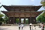 Large two-storied wooden gate with a hip-and-gable roof and passages in the three central bays.