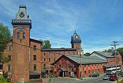 The mill complex, with four brick buildings and two towers.